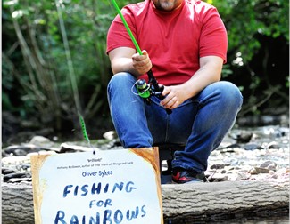 Oliver Sykes (wearing a red T shirt and blue jeans) holding a fishing Rod