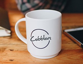 Photo of a coffee cup and mobile phone
