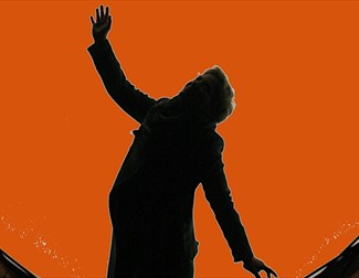 A silhouette against a orange dot