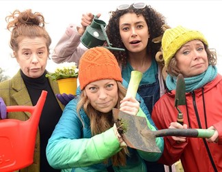 four ladies with gardening equipment