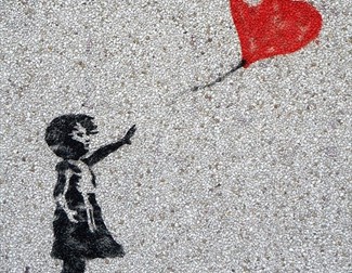 mural /graffiti art of girl holding heart shaped balloon