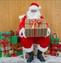 Father Christmas sitting surrounded by presents