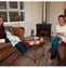 two ladies sitting knitting in front of log fire