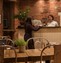 Images showing 2 ladies serving food over a cafe bar