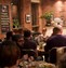 Dinners sitting about eating food in a cafe