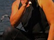 Image of Ayse Balko half kneeling talking into a microphone