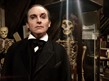 Person wearing black stood in front of two skelteons
