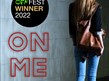 Image of a woman with her back to you holding a brown handbag and the words On me Next to her