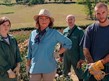 four people standing in a garden