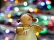 Angel ornament surrounded by christmas lights
