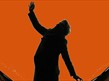 A silhouette against a orange dot