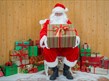 Father Christmas sitting surrounded by presents