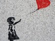 mural /graffiti art of girl holding heart shaped balloon