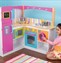 Girl playing in a toy kitchen