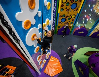Girl on the clip and climb wall