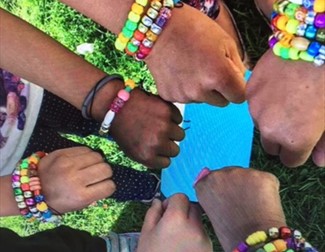 picture of children wrists with homemade bracelets