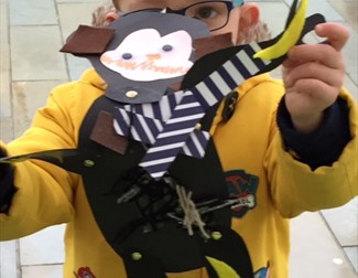 Child holding paper monkey