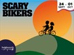 Silhouette of two bikers going over a hill