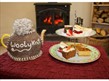 Cakes and tea pot with knitted wooley t cosy