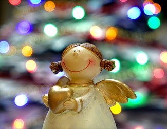 Angel ornament surrounded by christmas lights