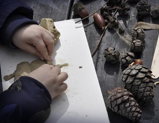 child's hands with clay modelling
