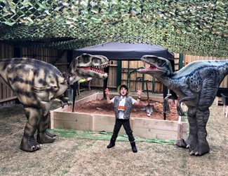 Child next to two dinosaurs