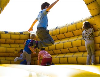Children Playing on Inflatable Castle
