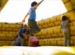 Children Playing on Inflatable Castle
