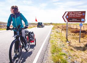 Kildonan Museum sign. Girl on bike