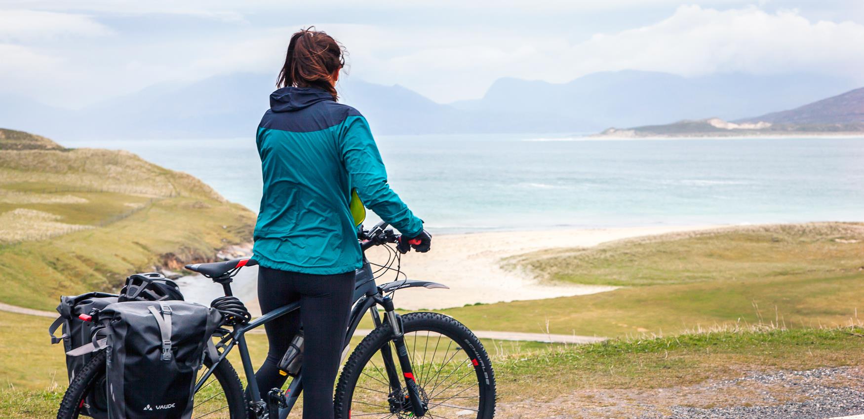 Cyclist looking accross to beach view, Harris