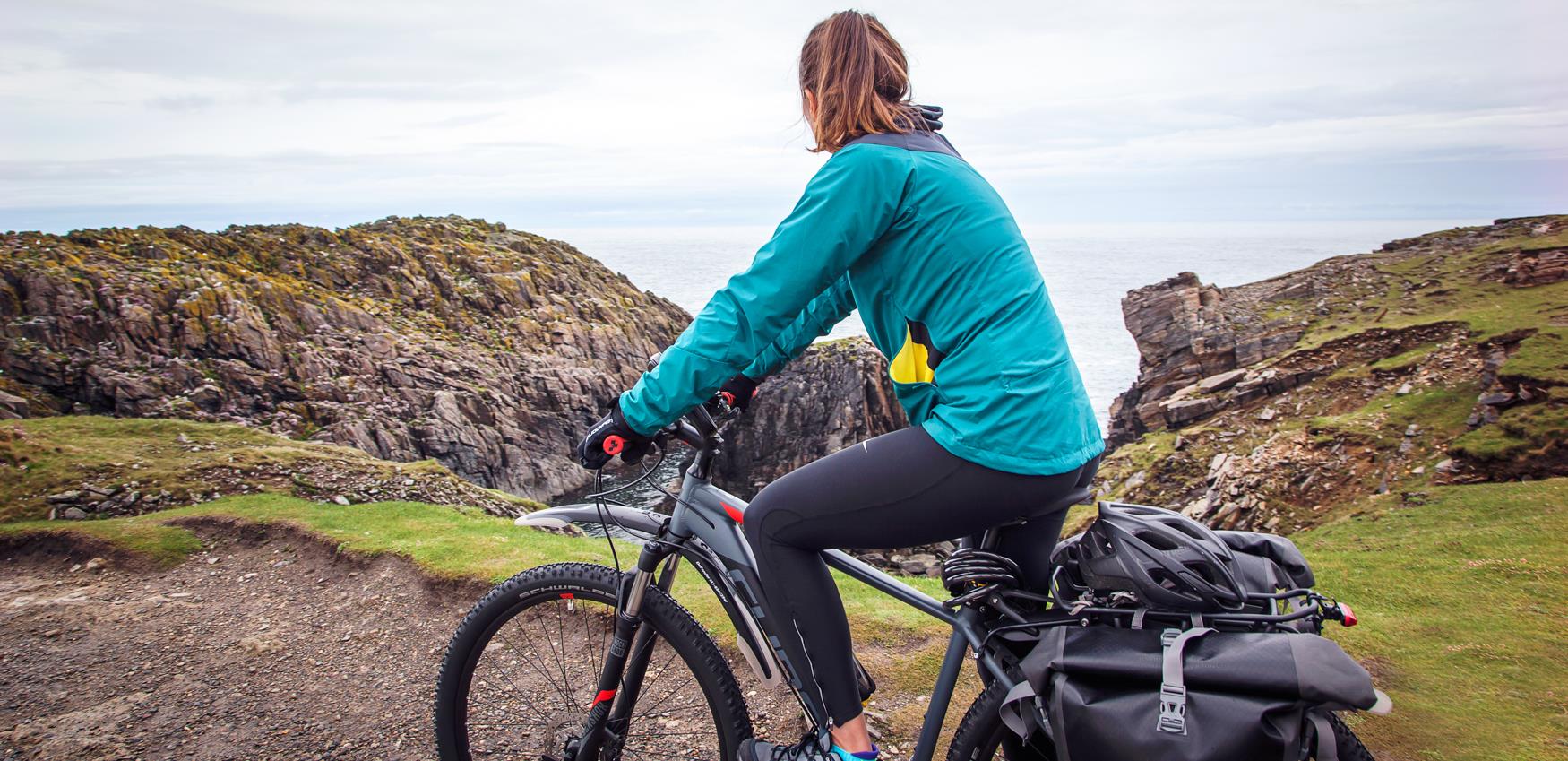 Cyclists finishing the Hebridean Way at But of Lewis, Ness