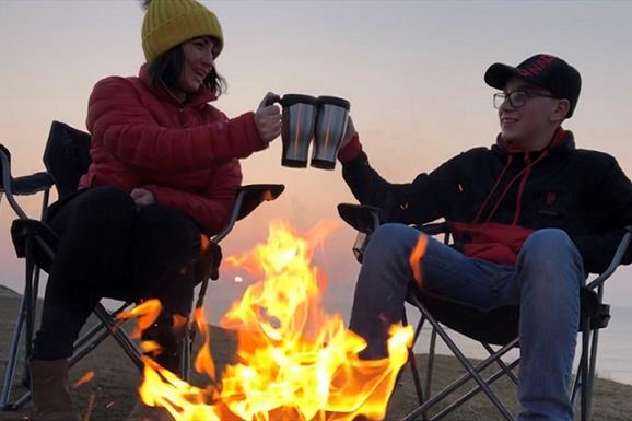 Heb360 Tours couple sitting at camp fire