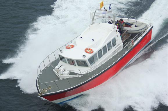 Kilda Cruises white & red boat on the sea