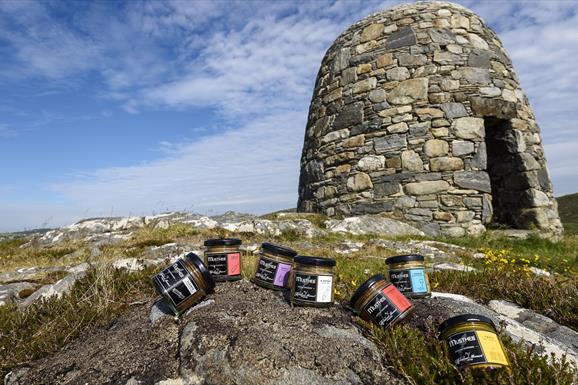 The Hebridean Mustard Company selection of mustard jars on rocks with cairn in the background