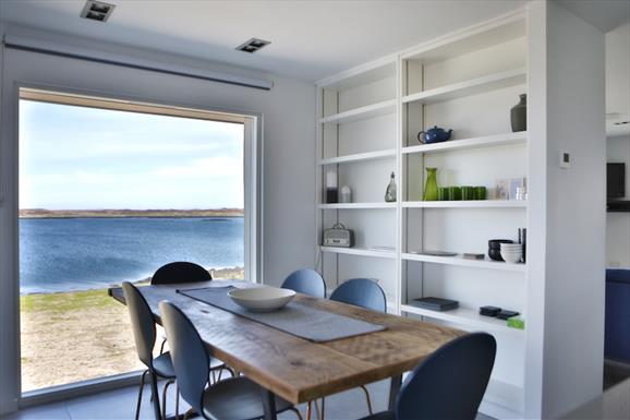 The Tidal House dining table with sea view