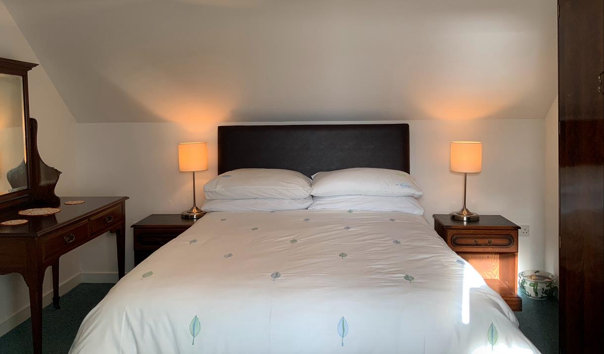 Upstairs bedroom, double bed, with white linen and antique furniture