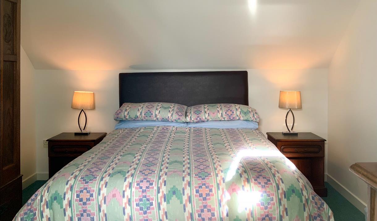 Upstairs bedroom, double bed, with white linen and antique furniture