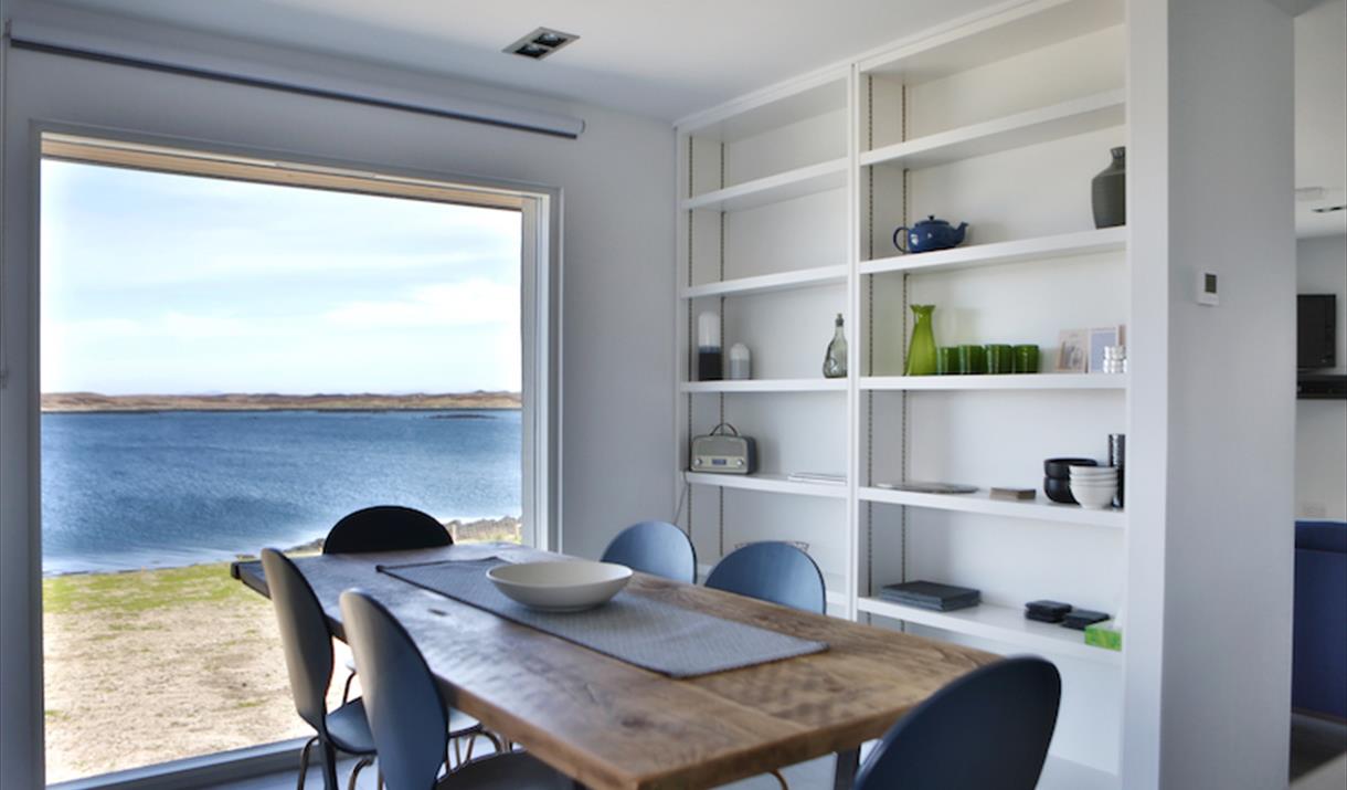 The Tidal House dining table with sea view