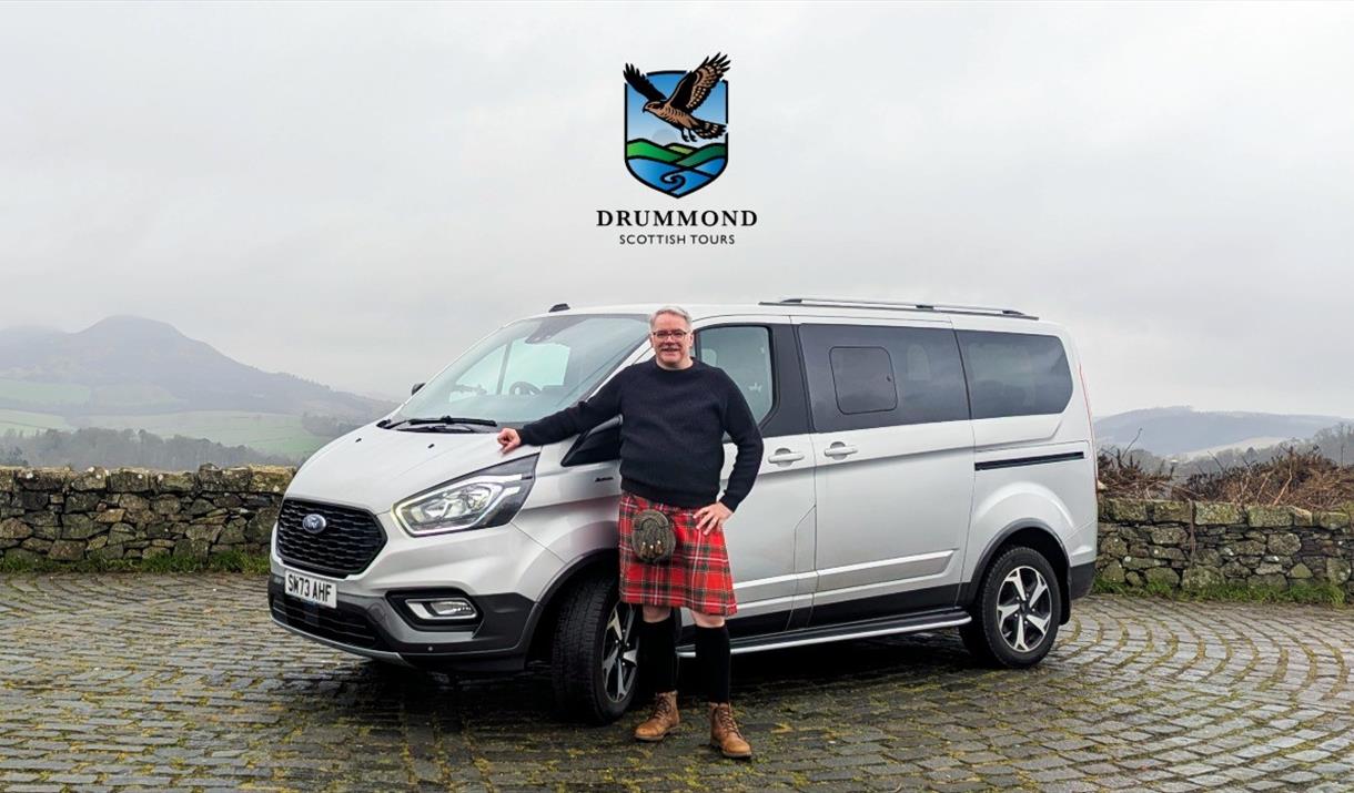 Drummond Scottish Tours Ford Tourneo vehicle with William Drummond standing in front.