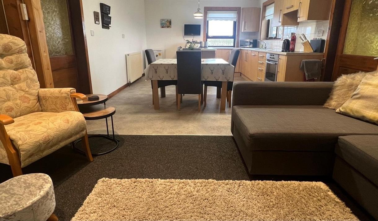 Kitchen view with family living space and dining table