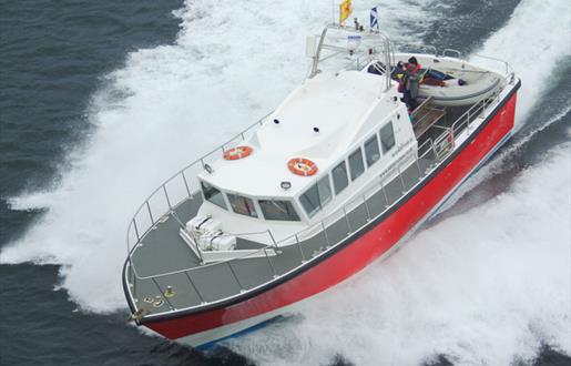 Kilda Cruises white & red boat on the sea