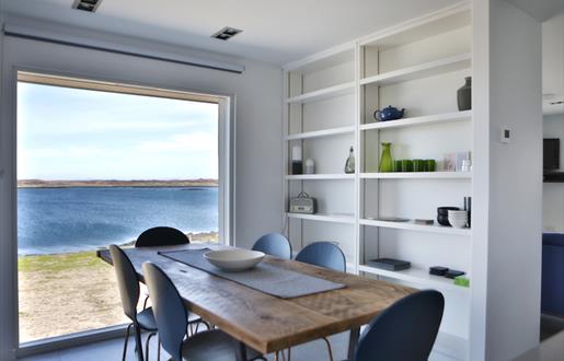 The Tidal House dining table with sea view