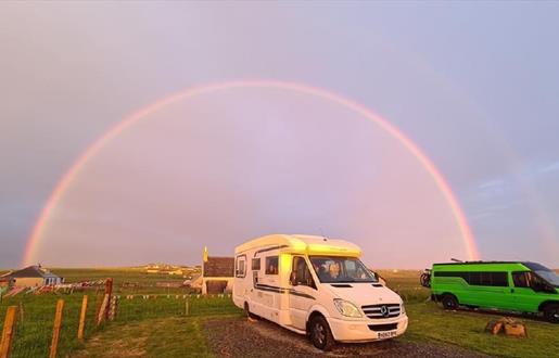 The Uncles Croft rainbow over parked vans