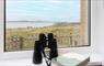 Stella Maris binoculars at window