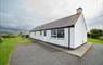 Am Bliochan self catering cottage north uist - exterior view with parking area.