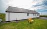 Am Bliochan self catering cottage north uist - exterior view with bench.