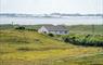 Am Bliochan self catering cottage north uist - exterior view with beach in the background