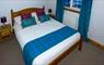 Dalhanna double bed with blue throw