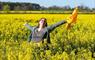 Eat Drink Hebrides - The Hebridean Mustard Company woman standing in field of yellow flowers