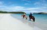 Traigh Mhor Pony Trekking 2 horses and riders in the sea